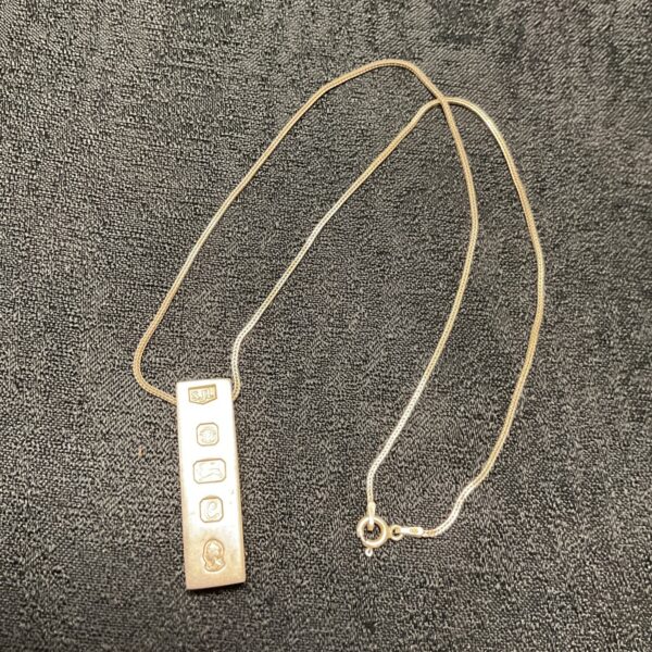 Hallmarked sterling silver ingot pendant and 18 inch necklace.