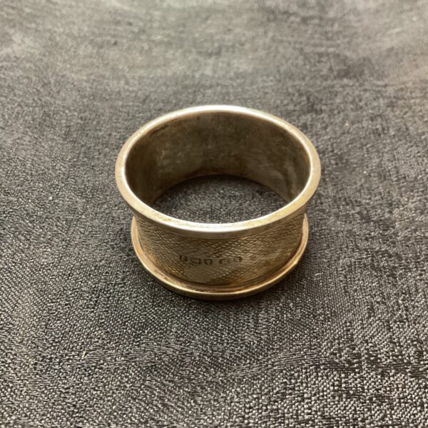 Hallmarked sterling silver napkin ring with textured band.