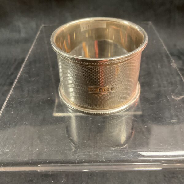 Hallmarked sterling silver napkin ring, vintage collectible, elegant table setting.