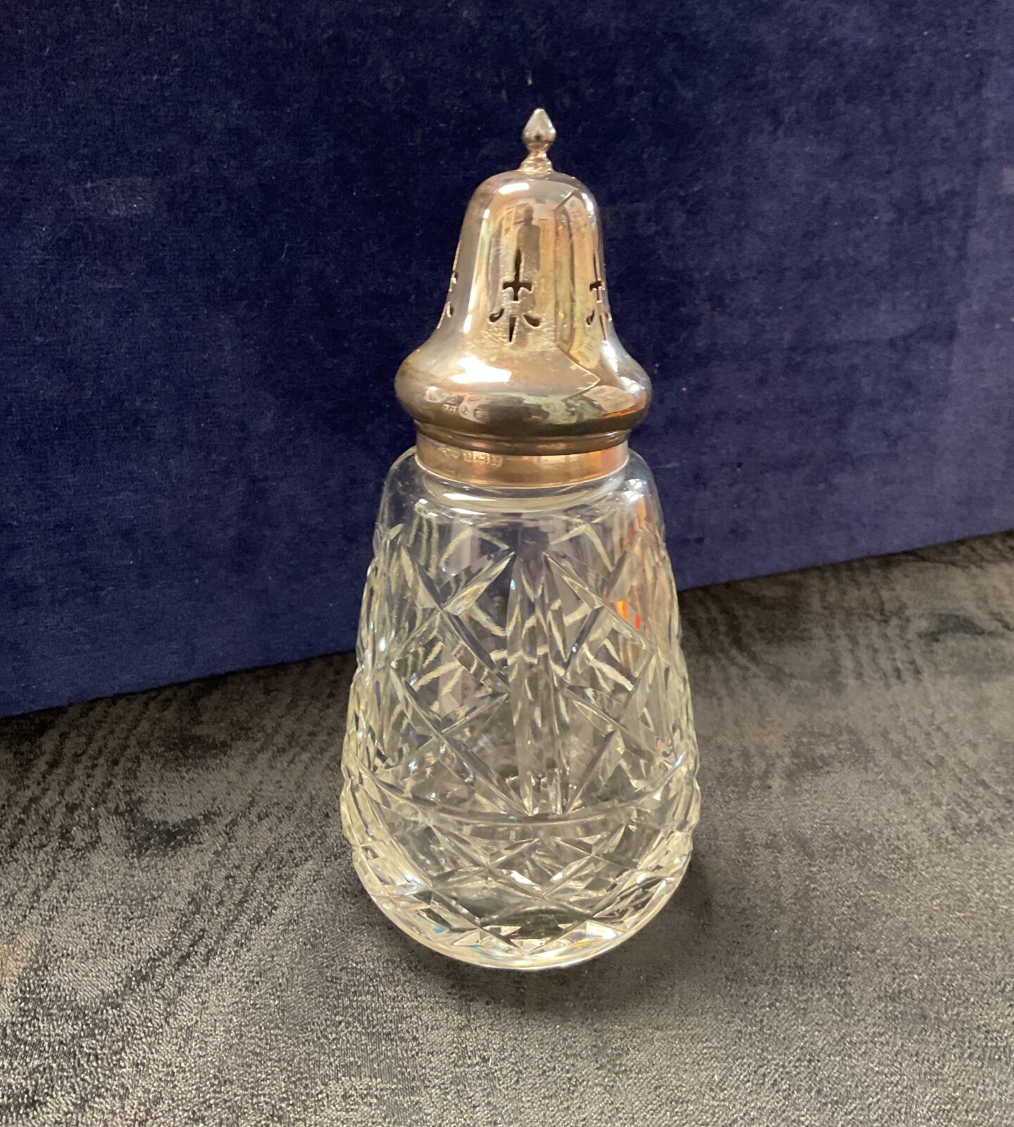 Vintage sterling silver sifter with cut glass body.