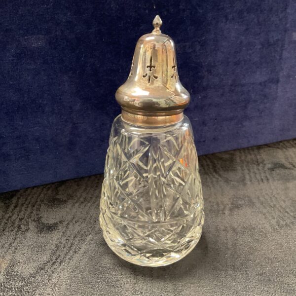 Vintage sterling silver sifter with cut glass body.