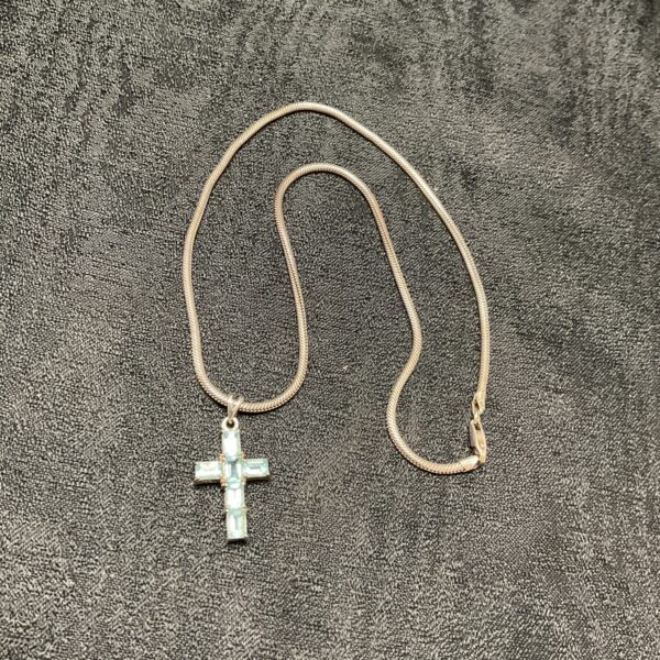 Sterling silver necklace with a vibrant topaz cross pendant.