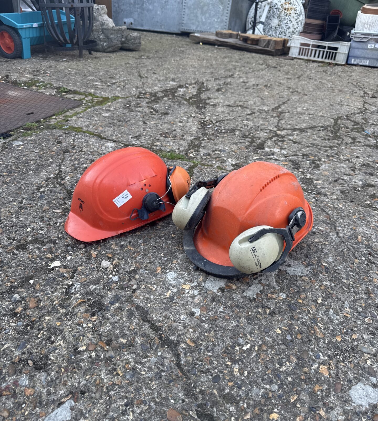 Used Stihl hard hat with ear defenders for work safety.