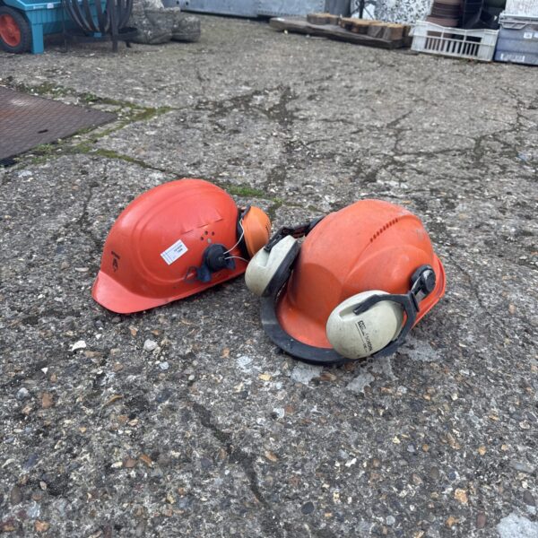 Used Stihl hard hat with ear defenders for work safety.