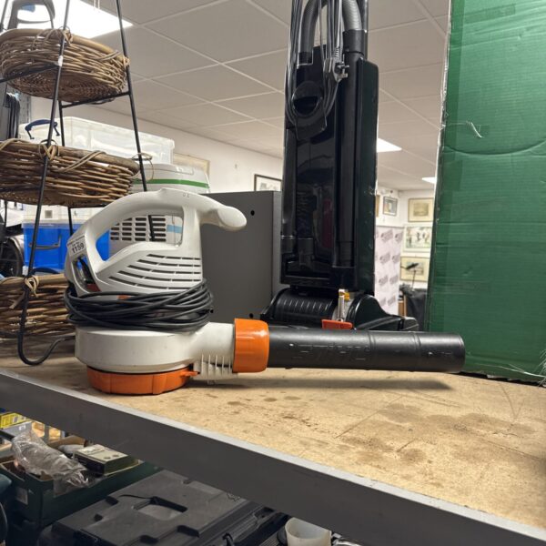 Stihl SHE71 corded leaf blower for garden cleanup.