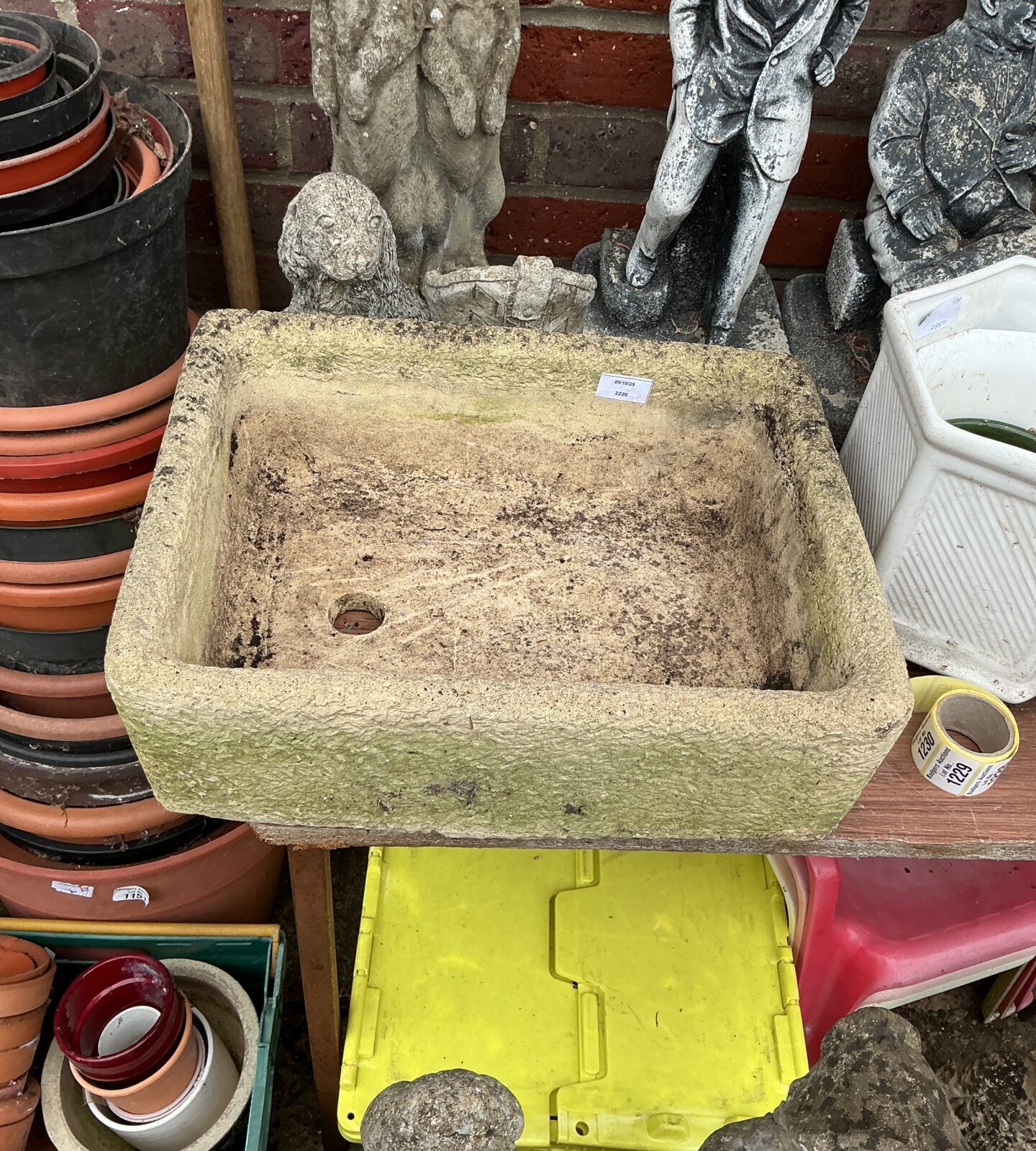 Weathered stone garden basin ideal for outdoor water features or planting.