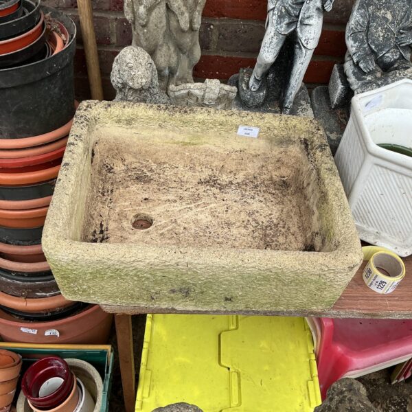 Weathered stone garden basin ideal for outdoor water features or planting.