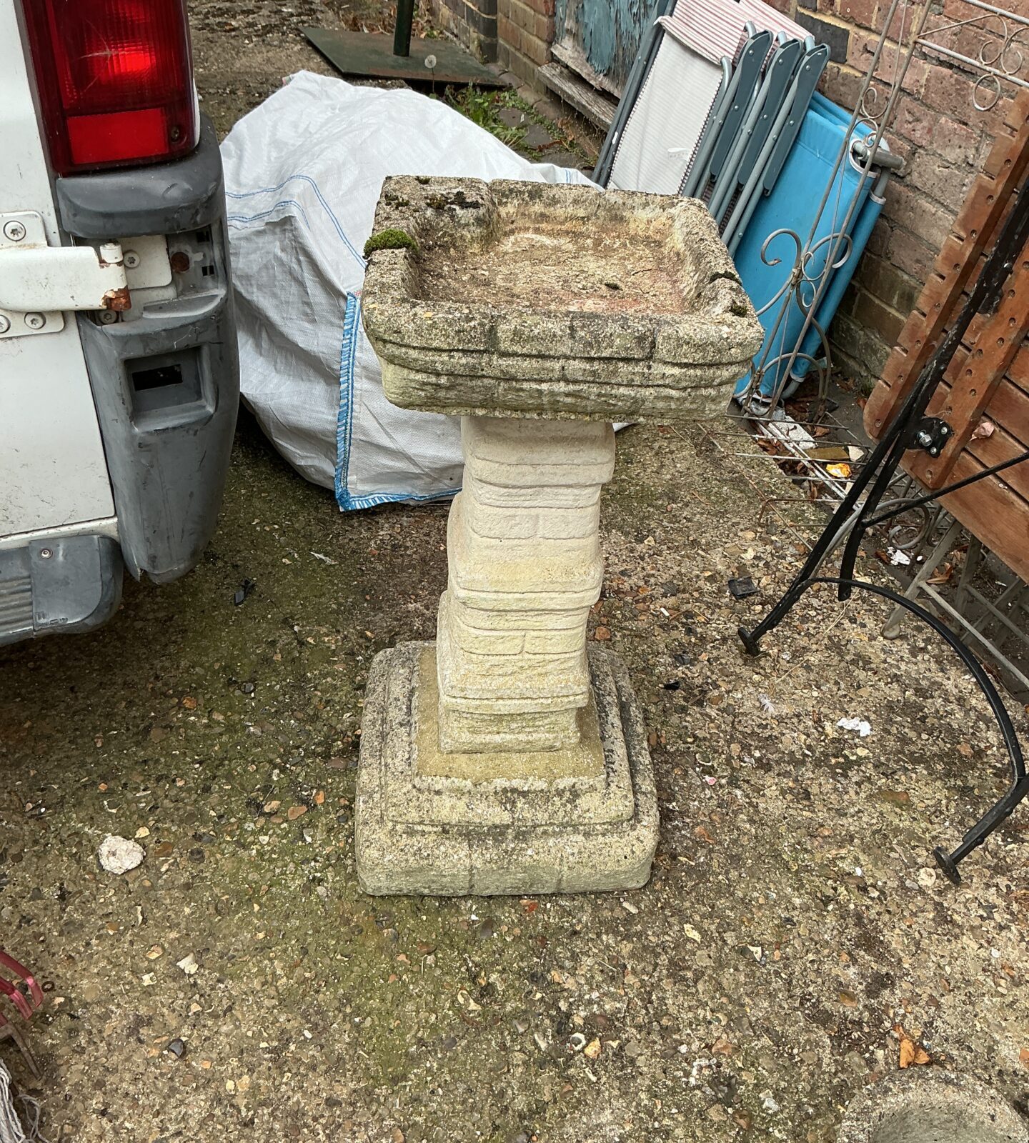 Weathered stone garden birdbath, ideal for attracting birds to your garden.