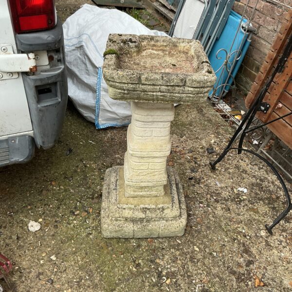 Weathered stone garden birdbath, ideal for attracting birds to your garden.