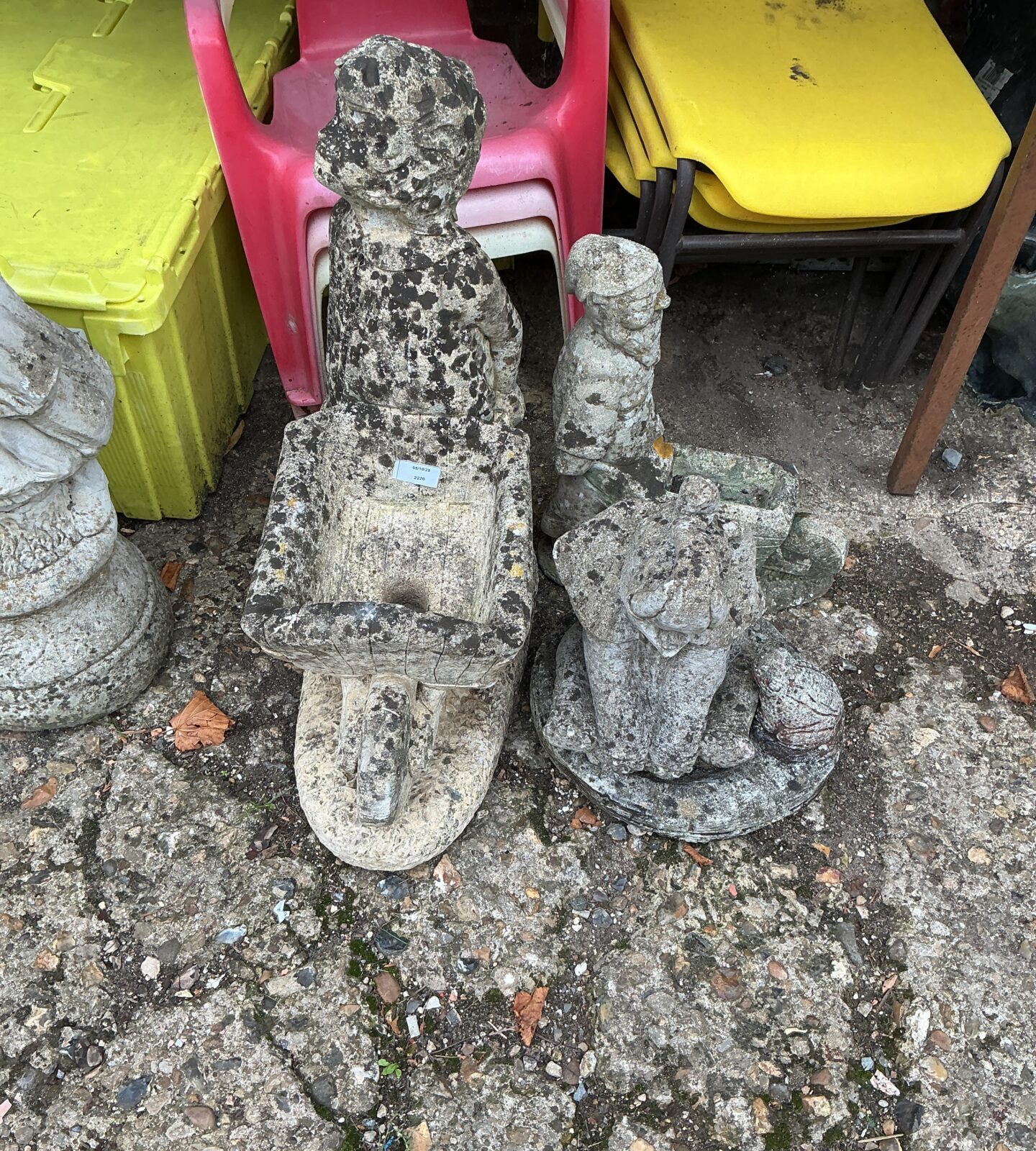 Charming stone garden ornament of a boy with a bird.