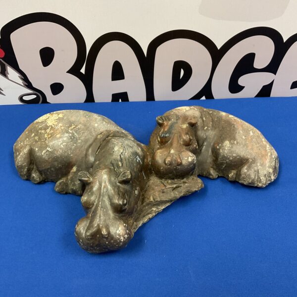 Carved stone hippopotamus sculpture, a substantial animal statue.