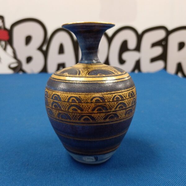 Small studio pottery vase with gold bands.