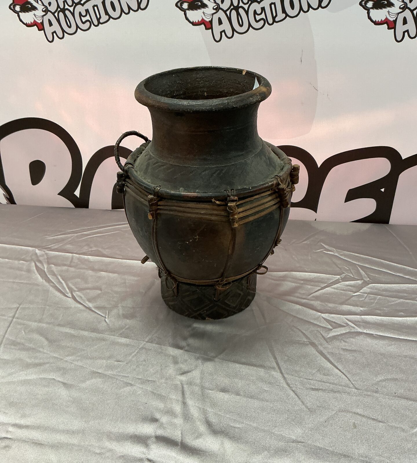 Unique studio pottery vase with a natural wicker base.