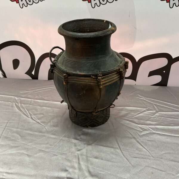 Unique studio pottery vase with a natural wicker base.