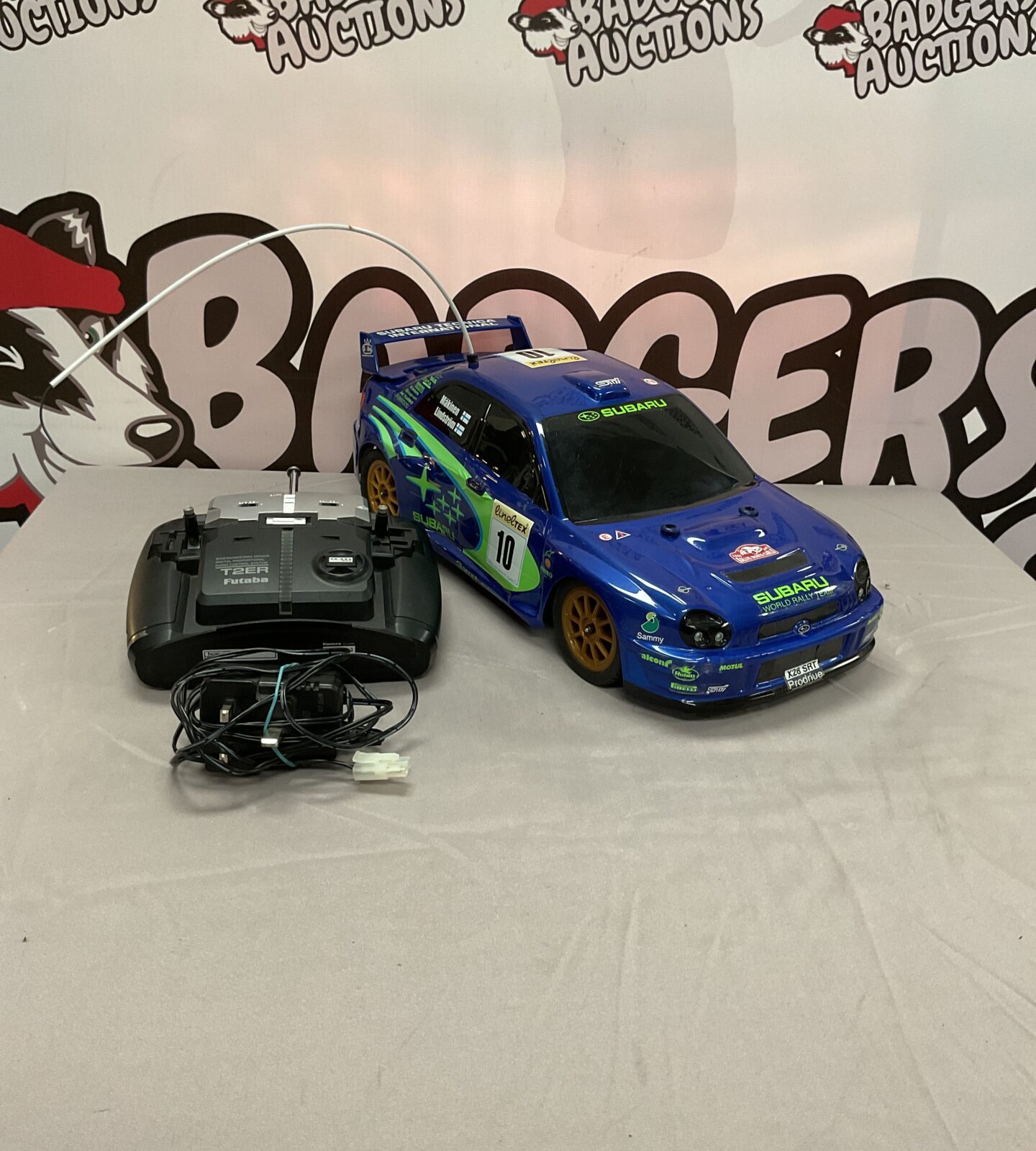 Detailed Sixico Subaru WRX STI rally RC car with remote.