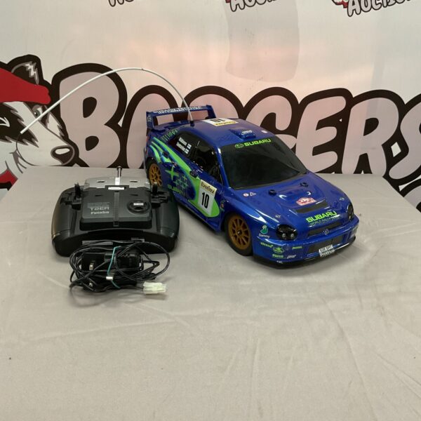 Detailed Sixico Subaru WRX STI rally RC car with remote.