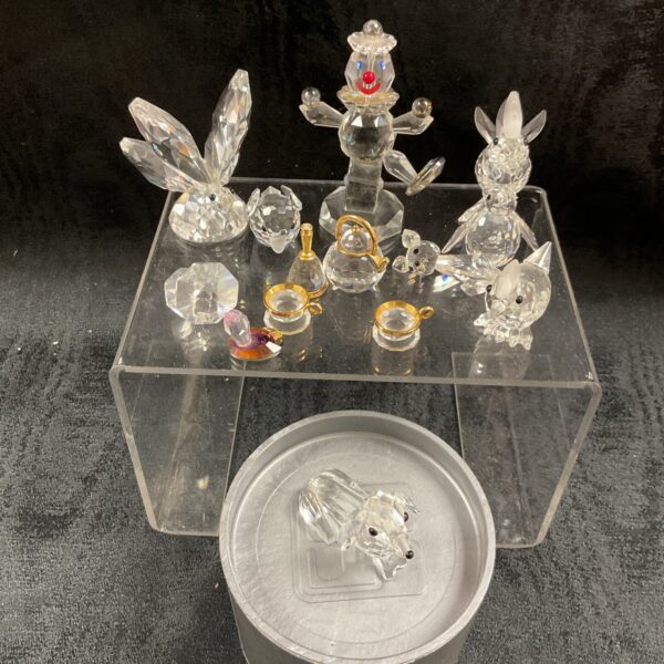 Stunning Swarovski crystal animal collection displayed on a clear base.
