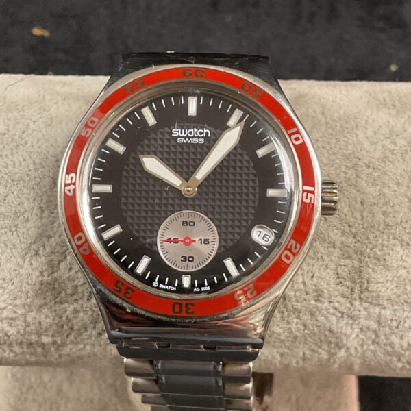 Black and steel Swatch quartz wristwatch with rotating bezel.