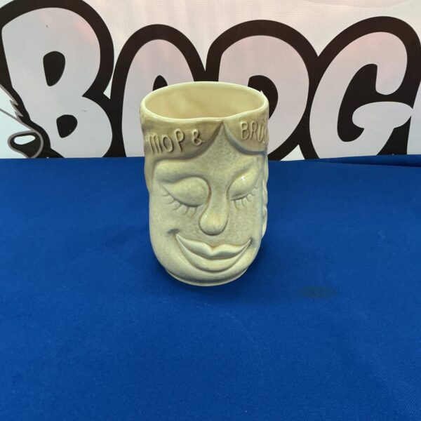 Vintage Sylvac pottery vase with dog and cleaning tools.