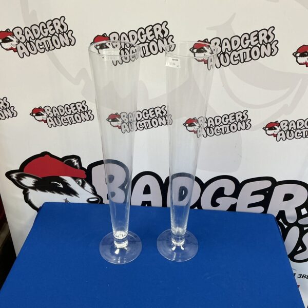 Two tall clear glass vases for home decor.