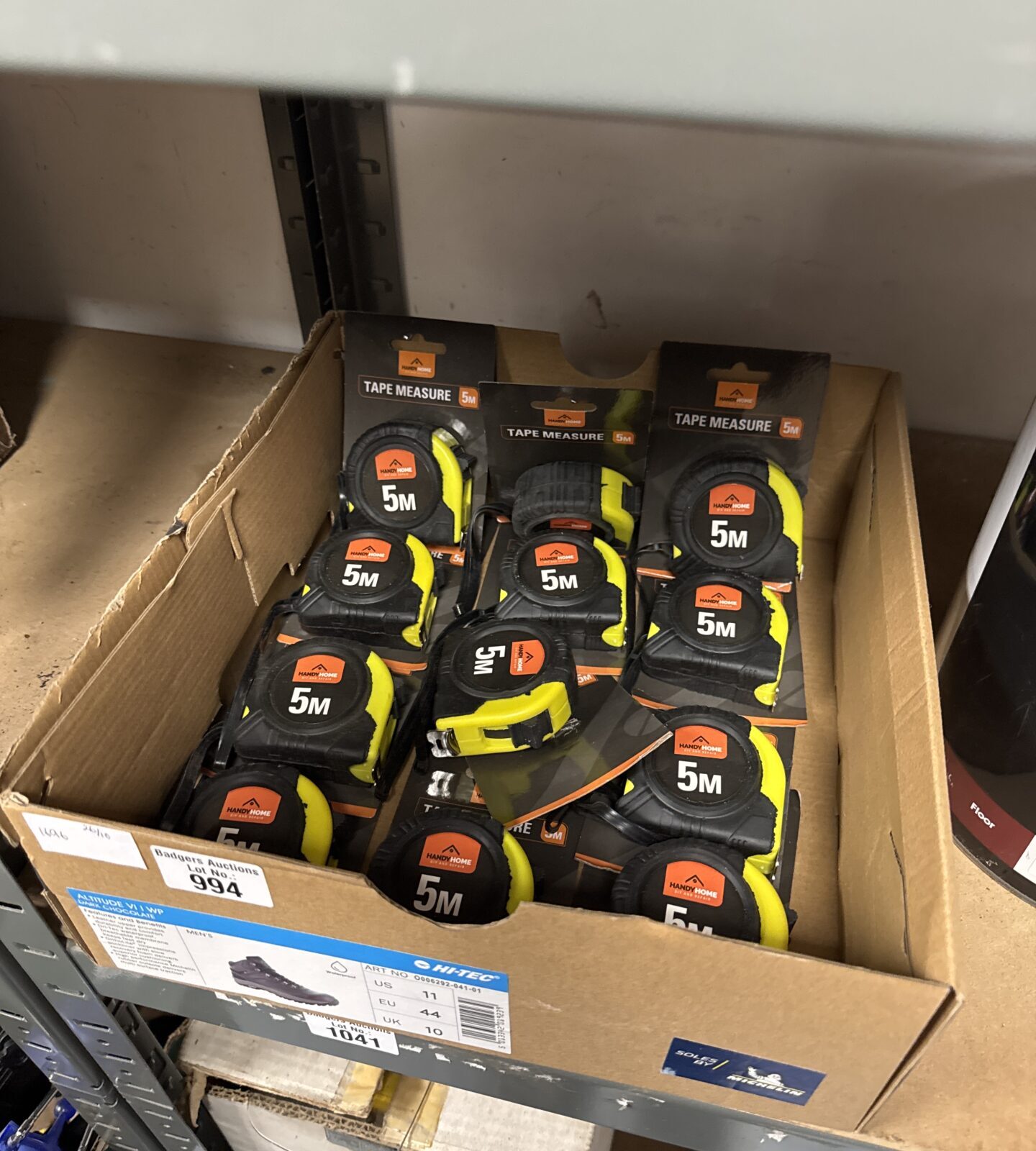Bulk lot of new yellow and black metric tape measures.