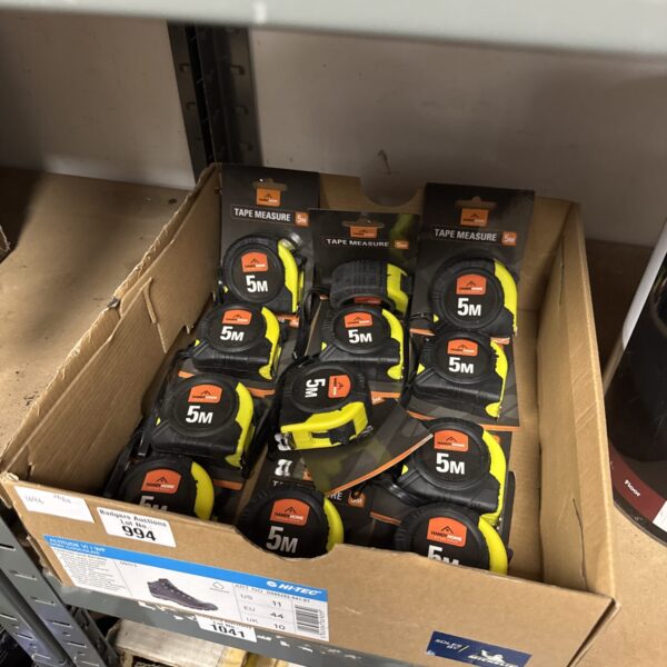 Bulk lot of new yellow and black metric tape measures.