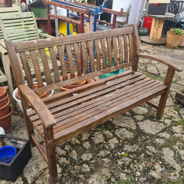 Weathered teak garden bench with slatted seat and back.