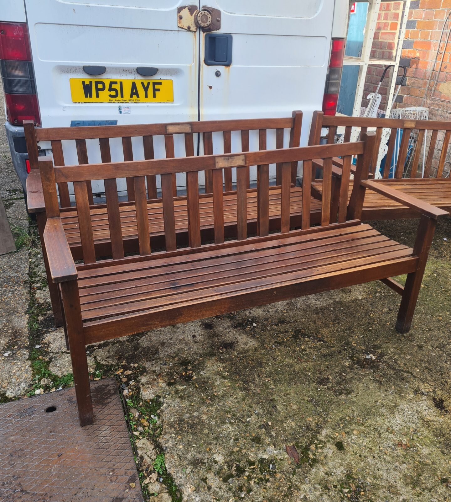 Solid teak garden bench with slatted seat and back.