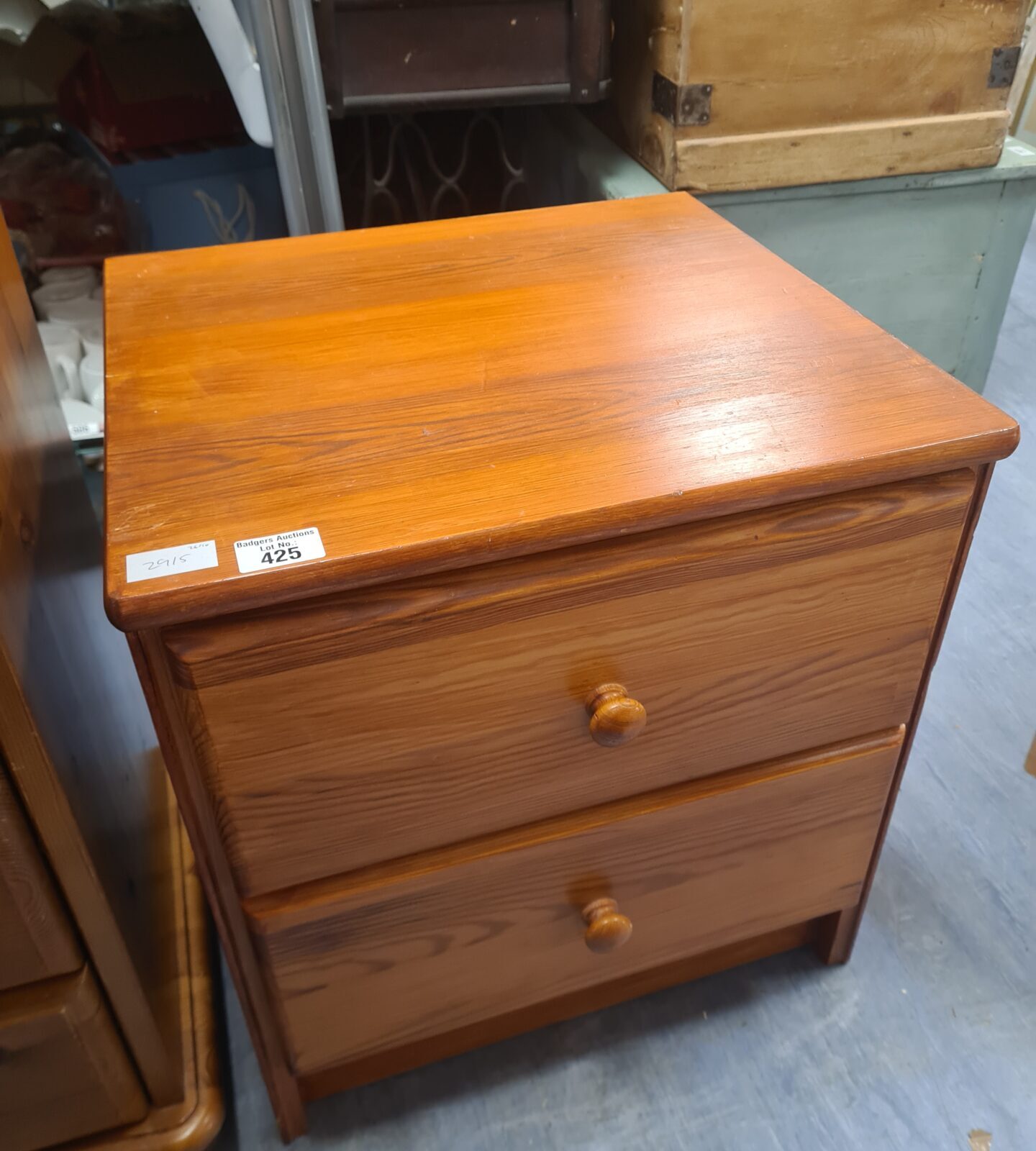 Vintage teak two-drawer cabinet with warm wood tones.