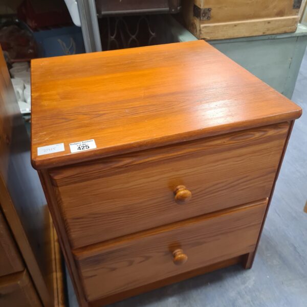 Vintage teak two-drawer cabinet with warm wood tones.