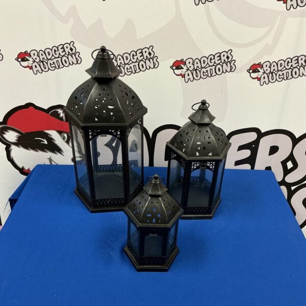Set of three teal decorative lanterns for ambient lighting.