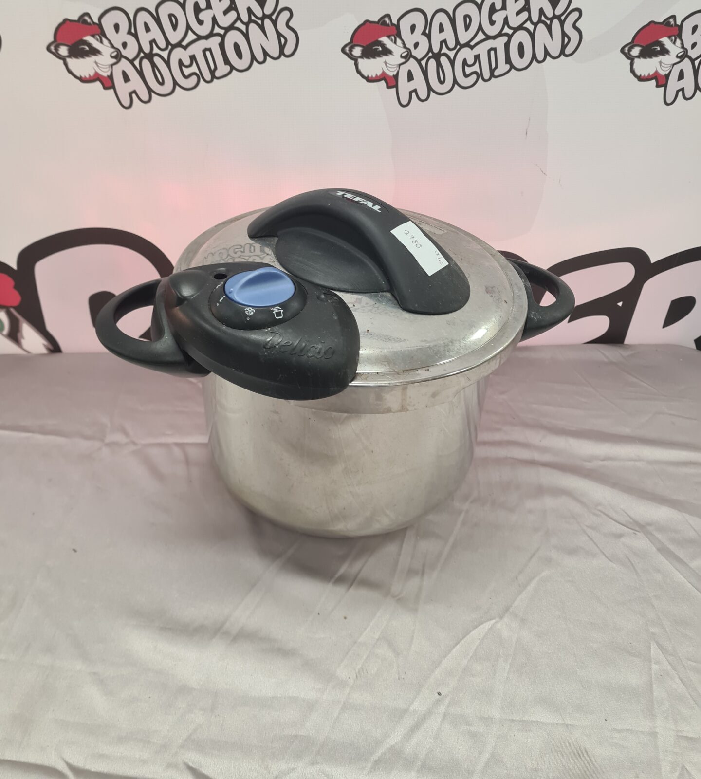 Front view of a silver Tefal slow cooker with lid.