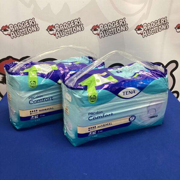 Sealed packs of Tena Pro Skin Comfort Pads for incontinence.