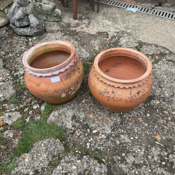 Pair of weathered terracotta garden pots for outdoor plants.