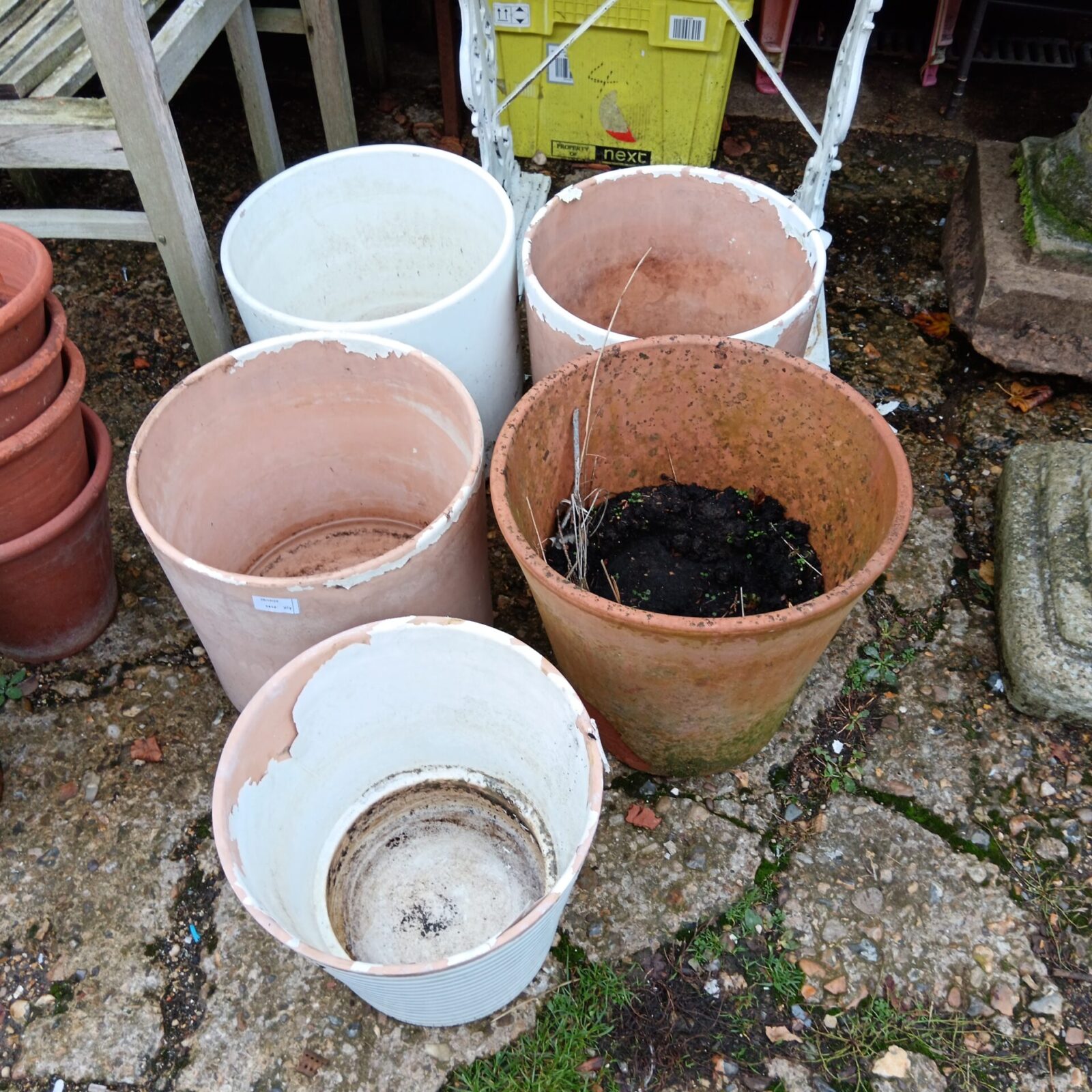 Lot of five large terracotta plant pots for garden use.