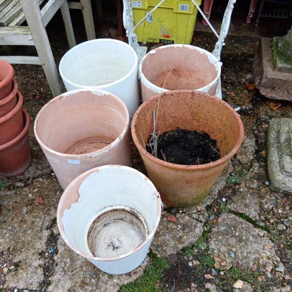 Lot of five large terracotta plant pots for garden use.