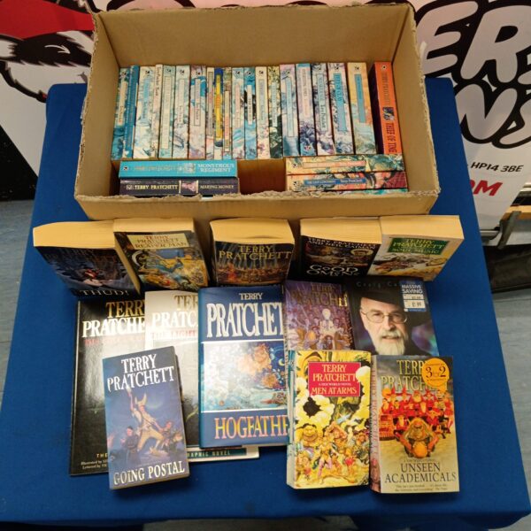 Stack of Terry Pratchett books, a large fantasy literature collection.