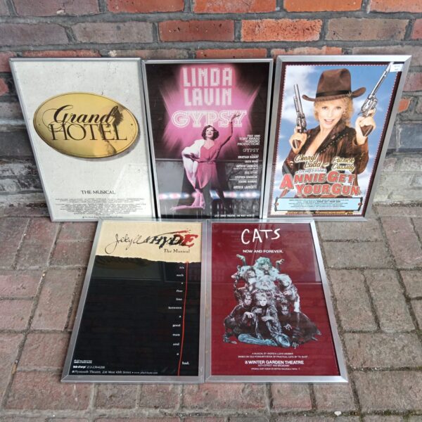 Framed theatre posters featuring Cats and Jekyll & Hyde musicals.