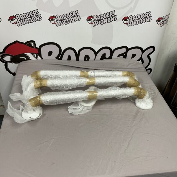 Three grab rails for bathroom safety and mobility assistance.