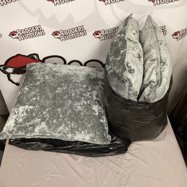 Three neutral-coloured sofa cushions for home decor.