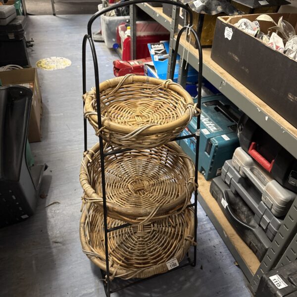 Vintage three-tier wicker basket stand for display and storage.
