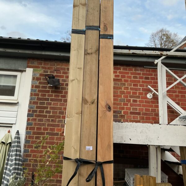 Three bundles of 9’6” timber stacked outdoors.