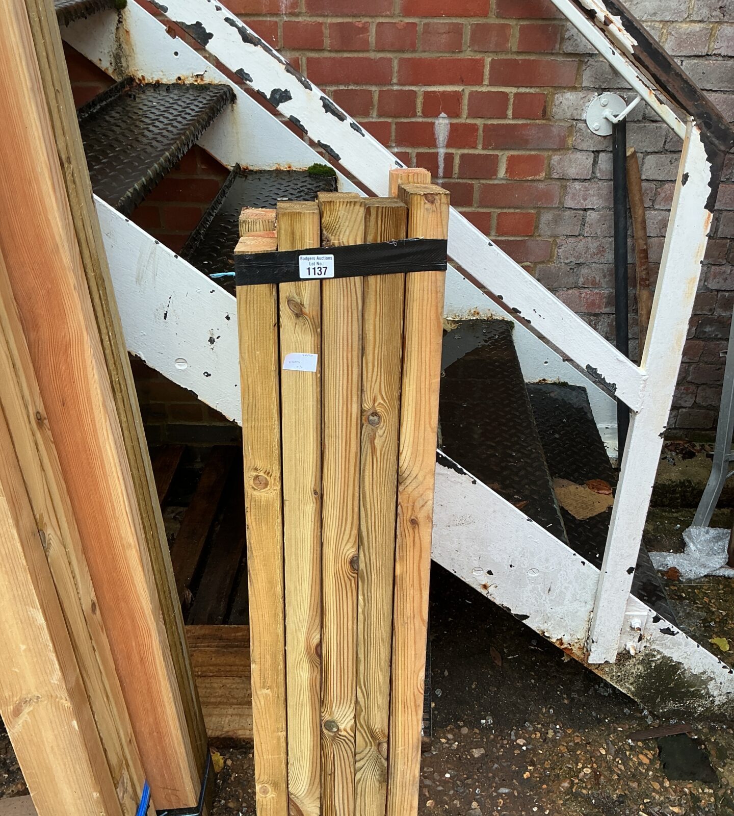 Three bundles of 3’6” timber stacked outdoors, ready for construction.