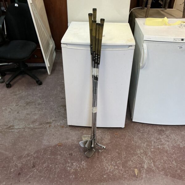 Vintage Tour Force golf club set displayed indoors.