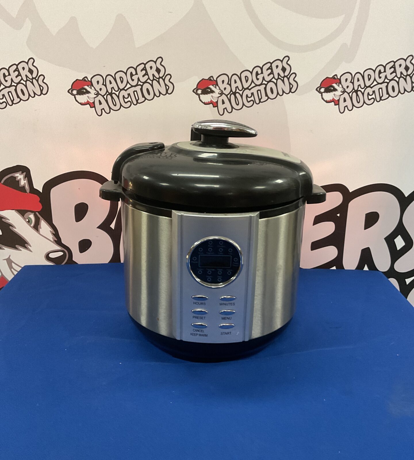 Front view of a stainless steel Tower pressure cooker with digital display.