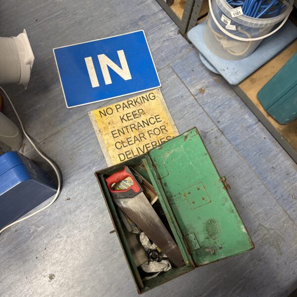 Vintage traffic signs and metal toolbox with tools inside.