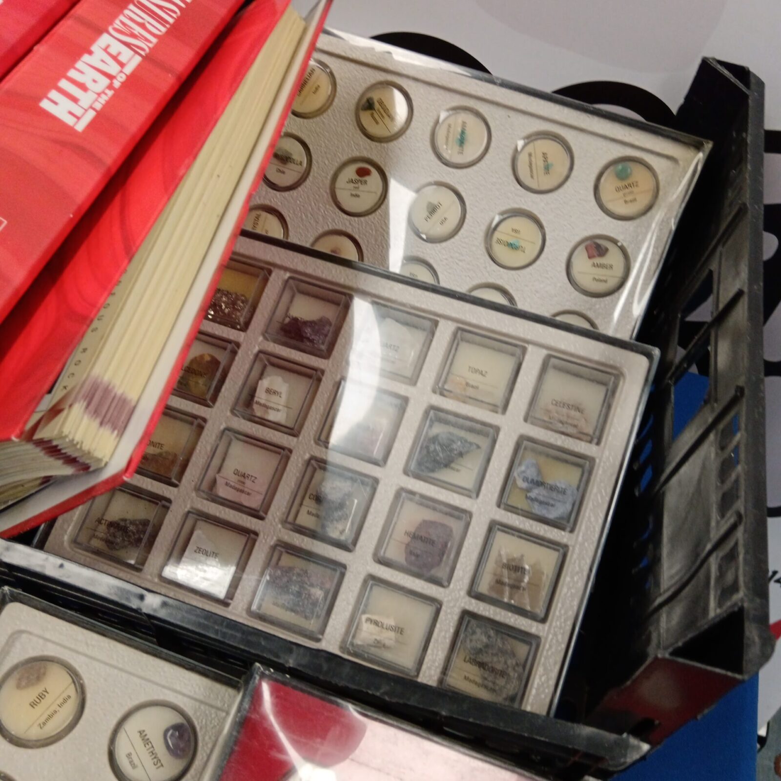 Close-up of Treasure Earth gemstone trays with polished stones.