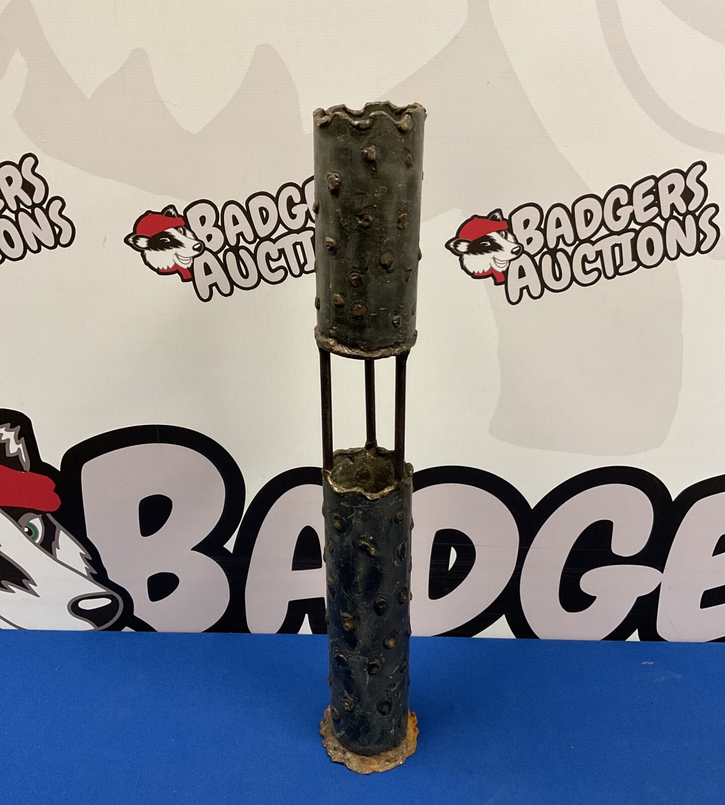Vintage iron trench art candlestick with rustic patina.