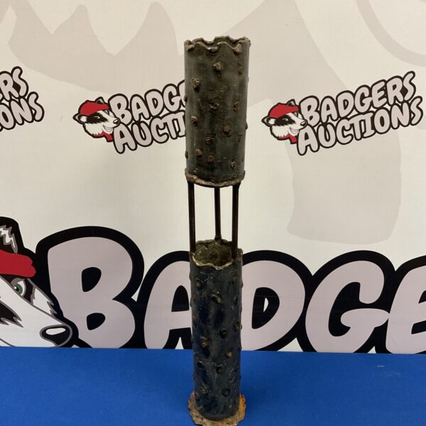Vintage iron trench art candlestick with rustic patina.