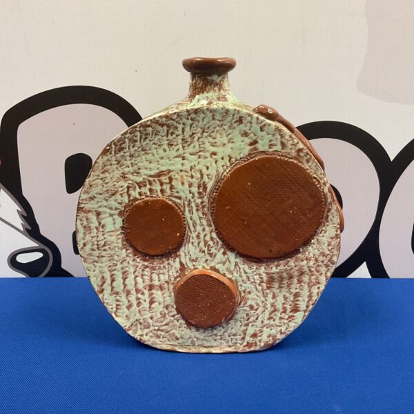 Textured Troika style pottery vase with a unique design.